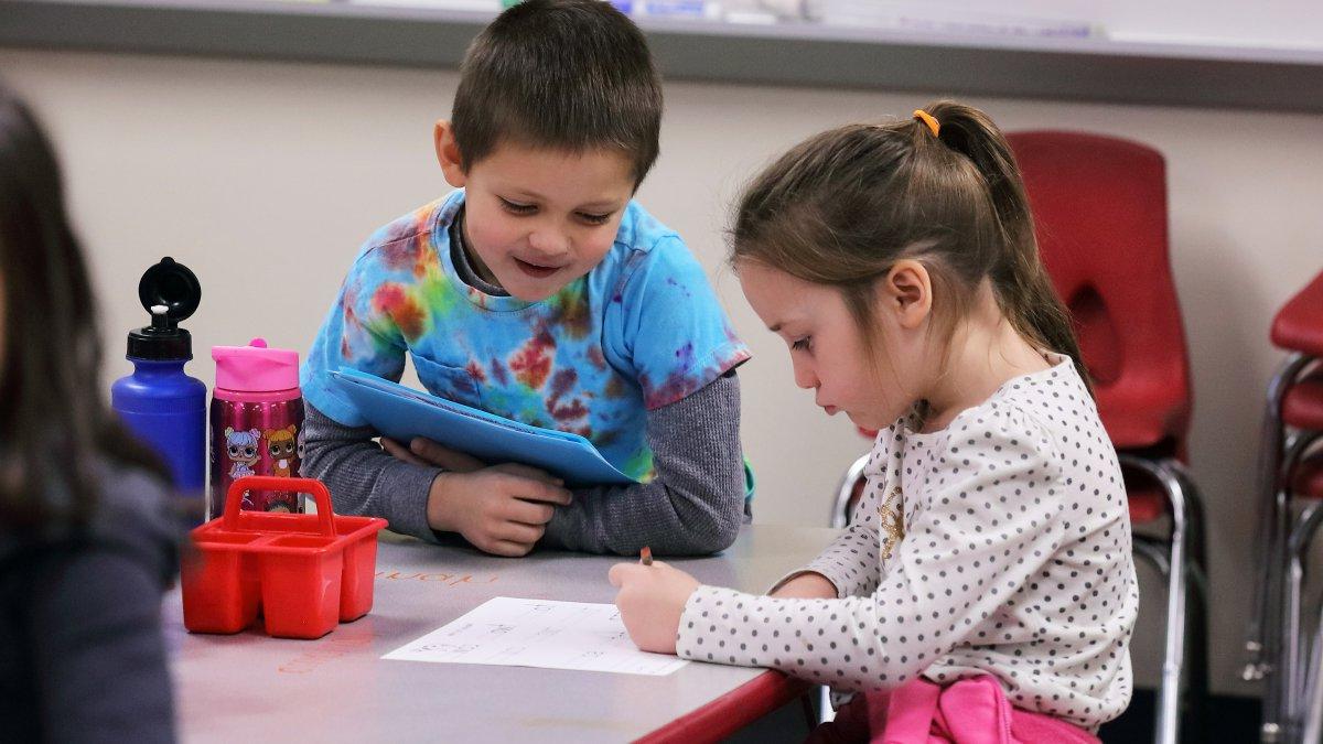 Two students work together on a worksheet