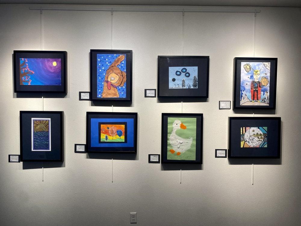 Photo of framed art on display at the Art Show